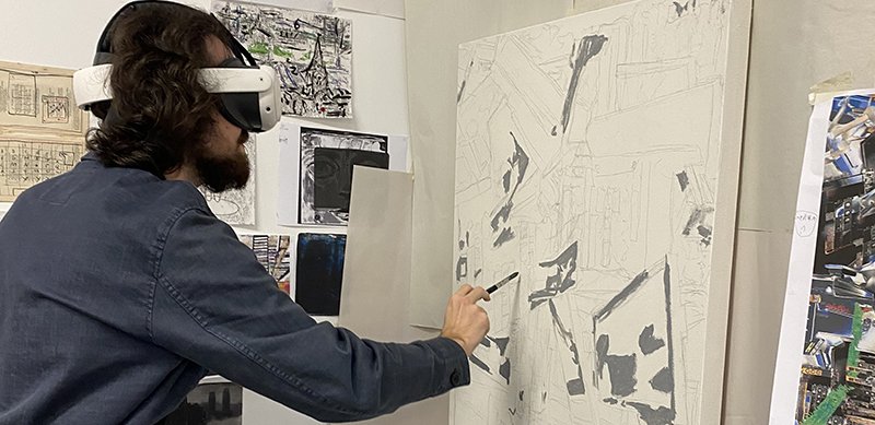 A learner using Contour on a virtual reality headset to produce artwork.