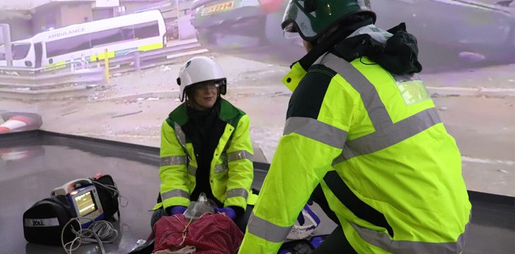 Students using immersive room to react to a car accident