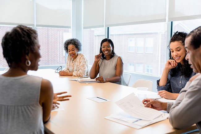 Colleagues in discussion during a review.