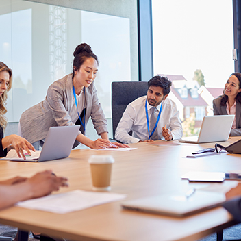 A team talking around a table in a meeting room.