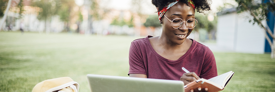 Female university student studying on a laptop.
