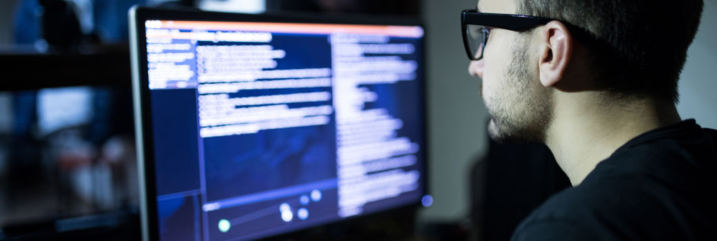 Man viewing code on a computer screen.