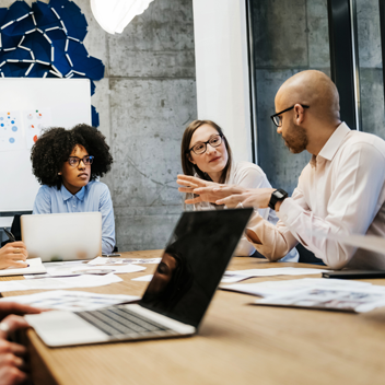 Three women and two men in a business meeting.