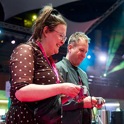 Female delegate listening with headphones at Digifest.