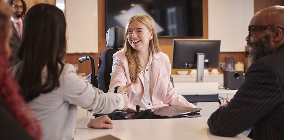 A female job interview candidate meeting interviewers.