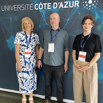 Three Jisc staff members at an event.